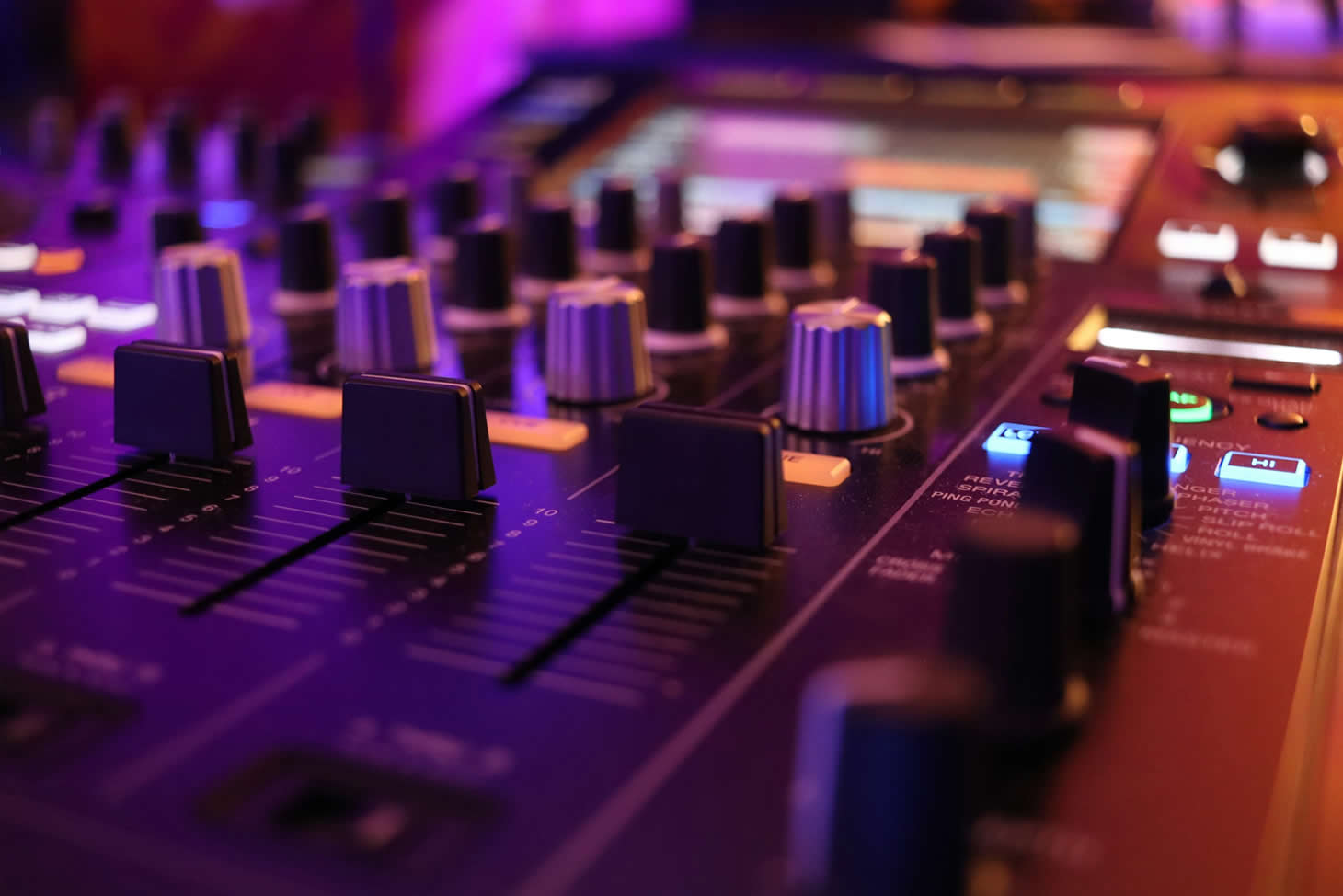 A close photo of a mixing board in a recording studio