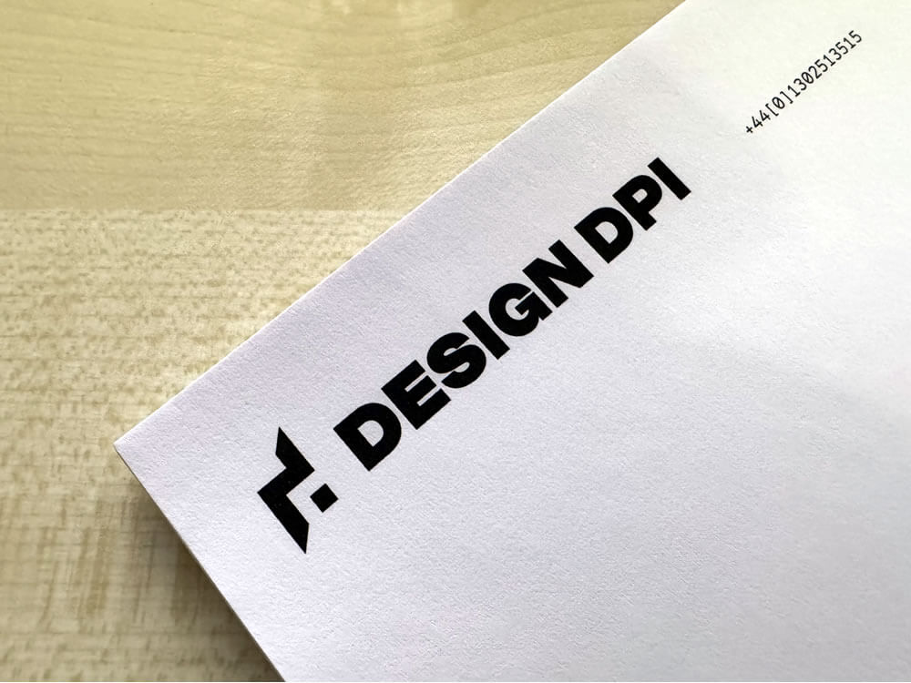 Photo of DESIGN DPI's letterheaded paper